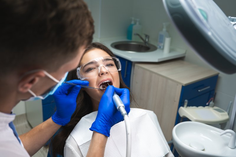 A woman receiving a non-surgical root canal