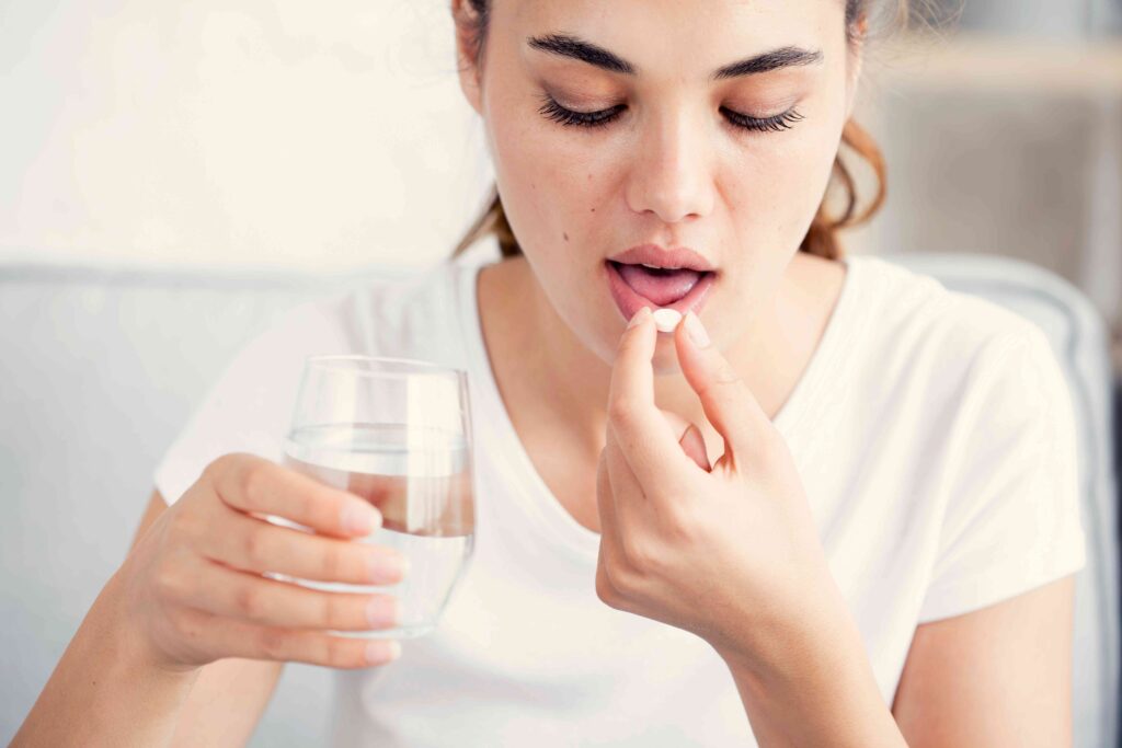 Woman taking a pill